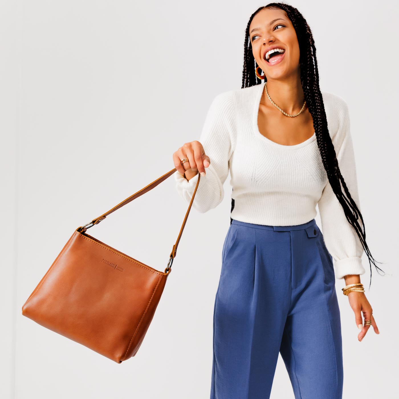 Honey*Small | Model carrying triangular shoulder bag with antiqued brass finished hardware