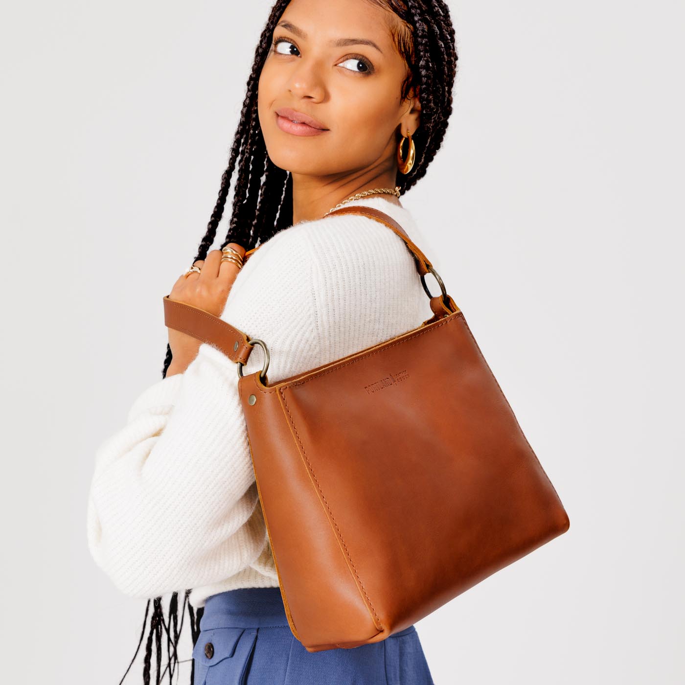 Honey*Small | Model carrying triangular shoulder bag with antiqued brass finished hardware