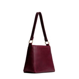 Cabernet Small | Large triangular shoulder bag with antiqued brass finished hardware