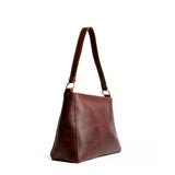 Cognac Small | Triangular shoulder bag with antiqued brass finished hardware