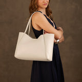 Pebbled Bone Large | Model holding midsize rectangular tote bag