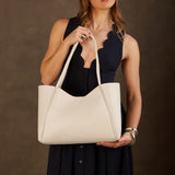 Pebbled Bone Large | Model holding midsize rectangular tote bag