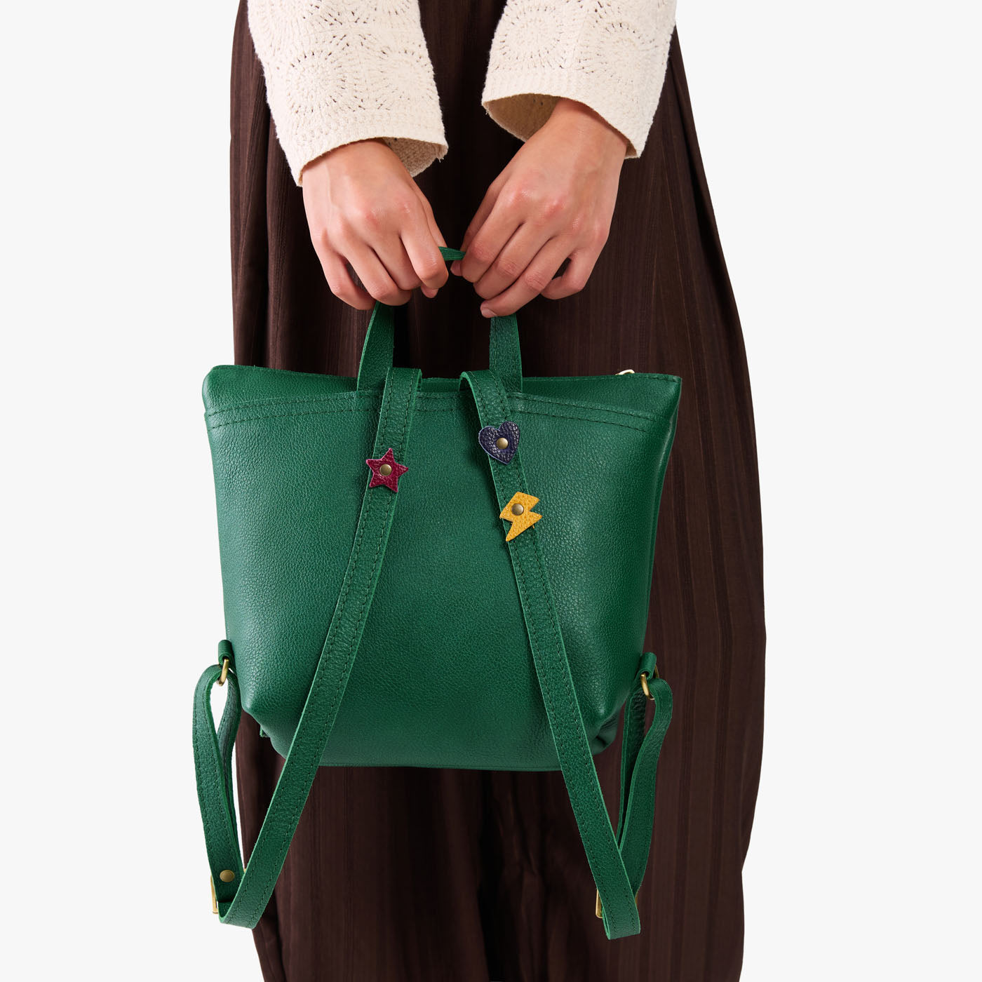 Bacalar | Model wearing a petite square slim leather tote backpack with zipper closure and adjustable straps