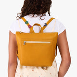 Sunshine | Model wearing a petite square slim leather tote backpack with zipper closure and adjustable straps