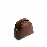 Coldbrew | Curved top leather pouch with zipper opening, flat base, and three metal tree emblems in front