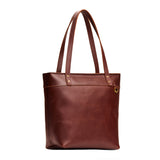 Cognac Medium Zipper | Model wearing leather tote bag with riveted straps and exterior key loop