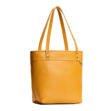 Sunshine Medium Zipper | Model wearing leather tote bag with riveted straps and exterior key loop
