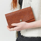 Meadow | Model holding leather wallet with snap closure